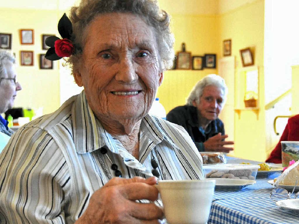 SLICE AND SMILES: Merle Rettke enjoys a cuppa at what she calls the happiest QCWA on the Downs. SLICE AND SMILES: Merle Rettke enjoys a cuppa at what she calls the happiest QCWA on the Downs.